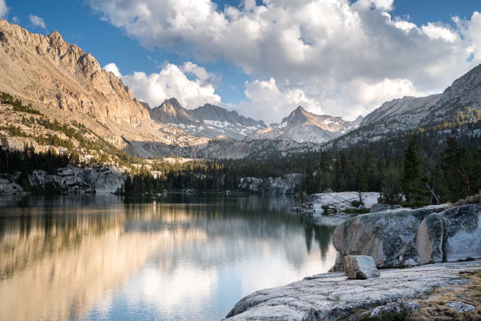 A lake in front of a mountain range