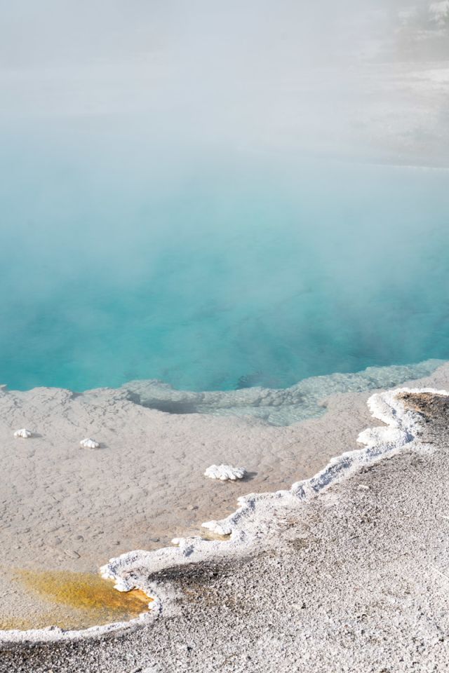 A large hot spring with blue water.