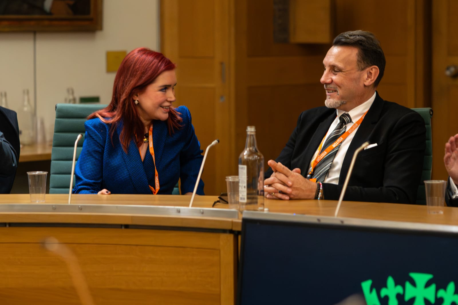 Two industry participants in conversation at a parliamentary event