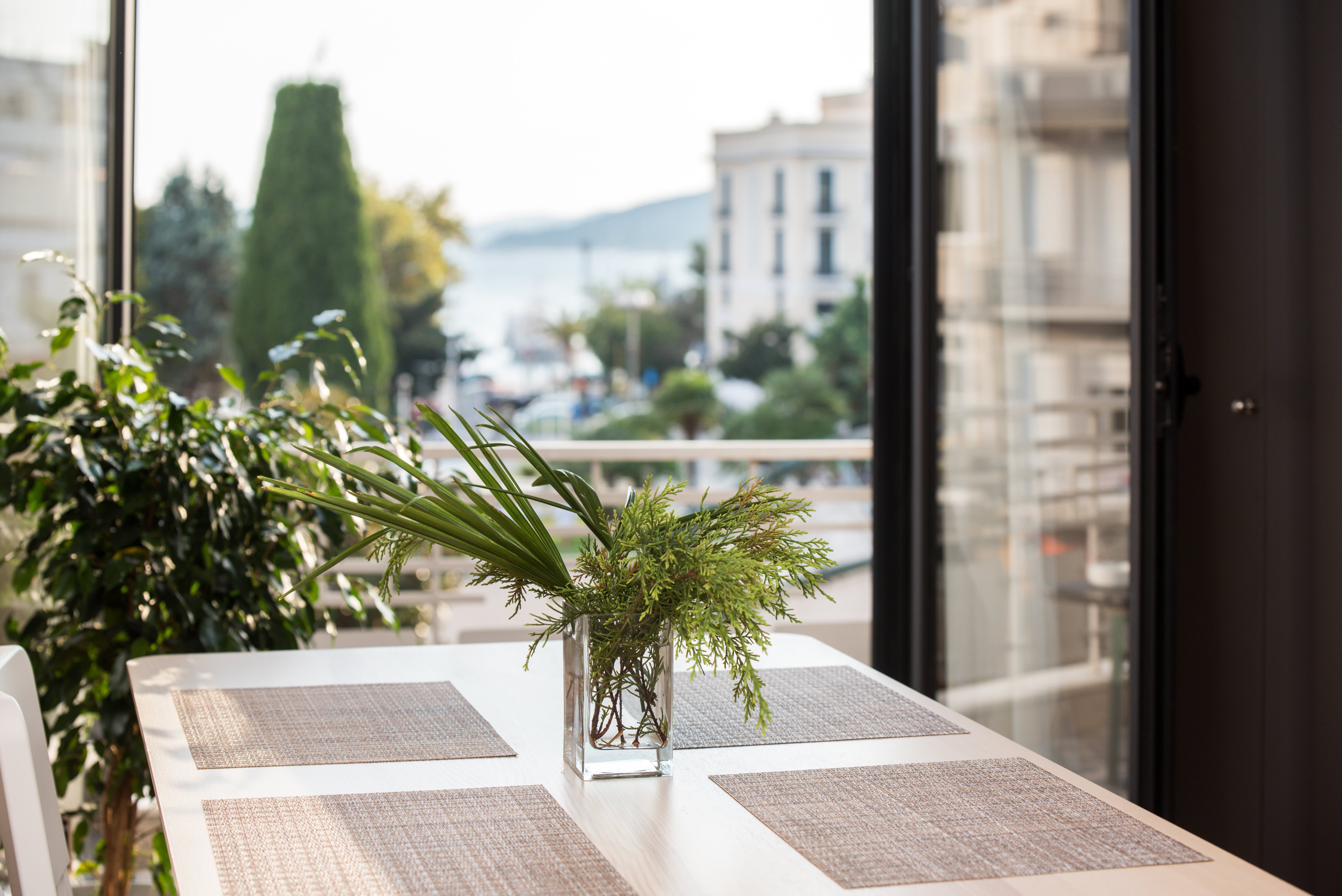 sustainable planting on balcony with chair and table for dining