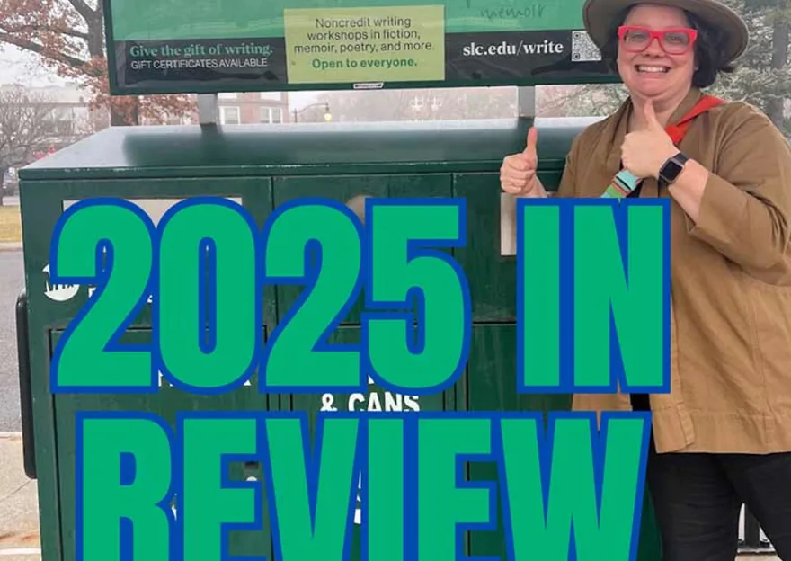 Person in a hat and red glasses gives thumbs up in front of a writing workshop sign. Bold text reads "2025 IN REVIEW."