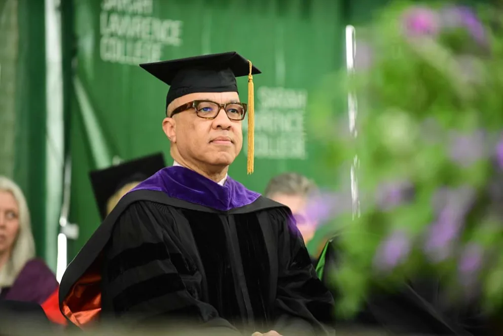 Academic in regalia at a graduation ceremony.