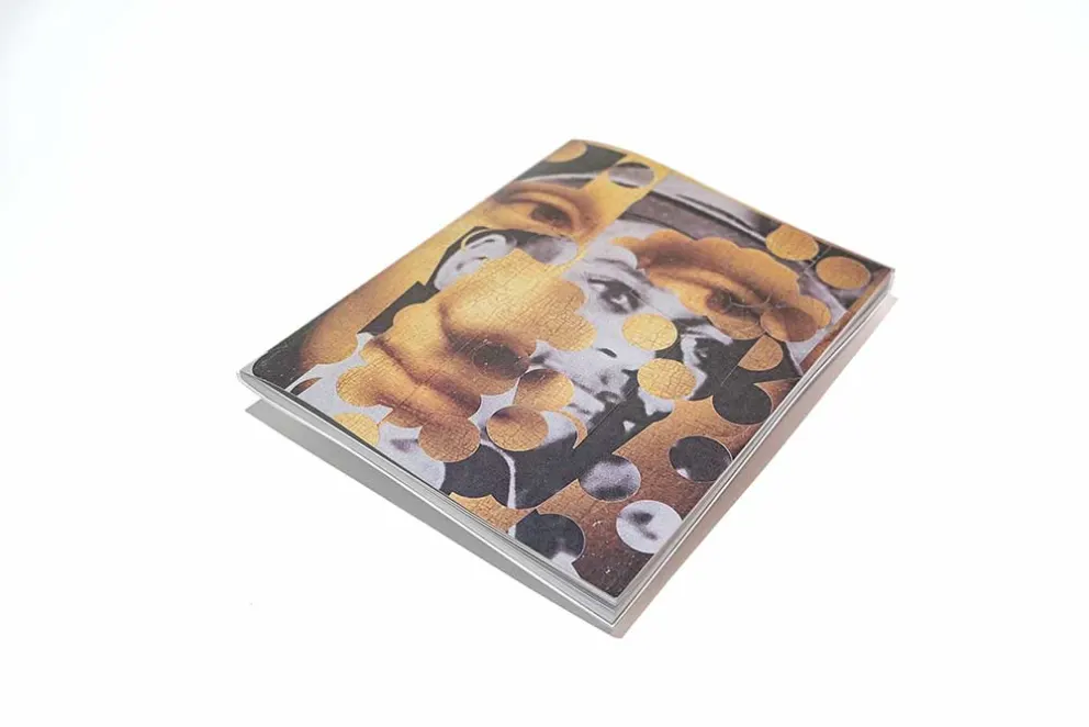 A book with an abstract cover featuring a collage of human faces and circular patterns in a sepia tone.