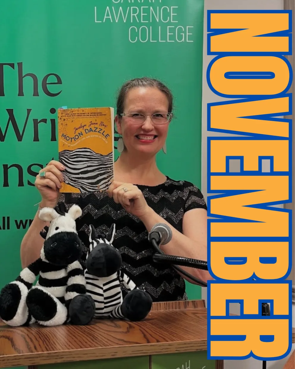 Person holding a book titled "Motion Dazzle" stands at a podium with two stuffed zebras, a green background, and "November" in bold text.