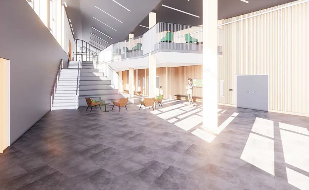 Spacious modern lobby with large windows, stairs, seating area, and upper-level balcony. Light floods the room, creating bright shadows.