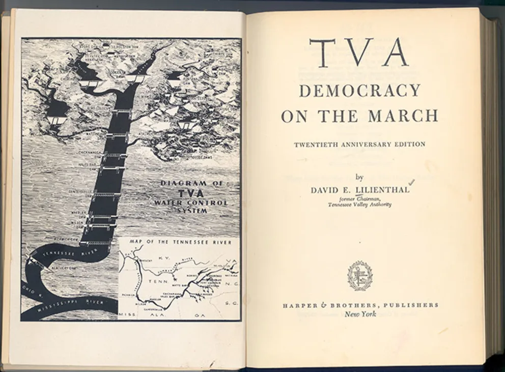 Open book showing a map of the TVA water control system on the left page and the title "TVA Democracy on the March" on the right page.