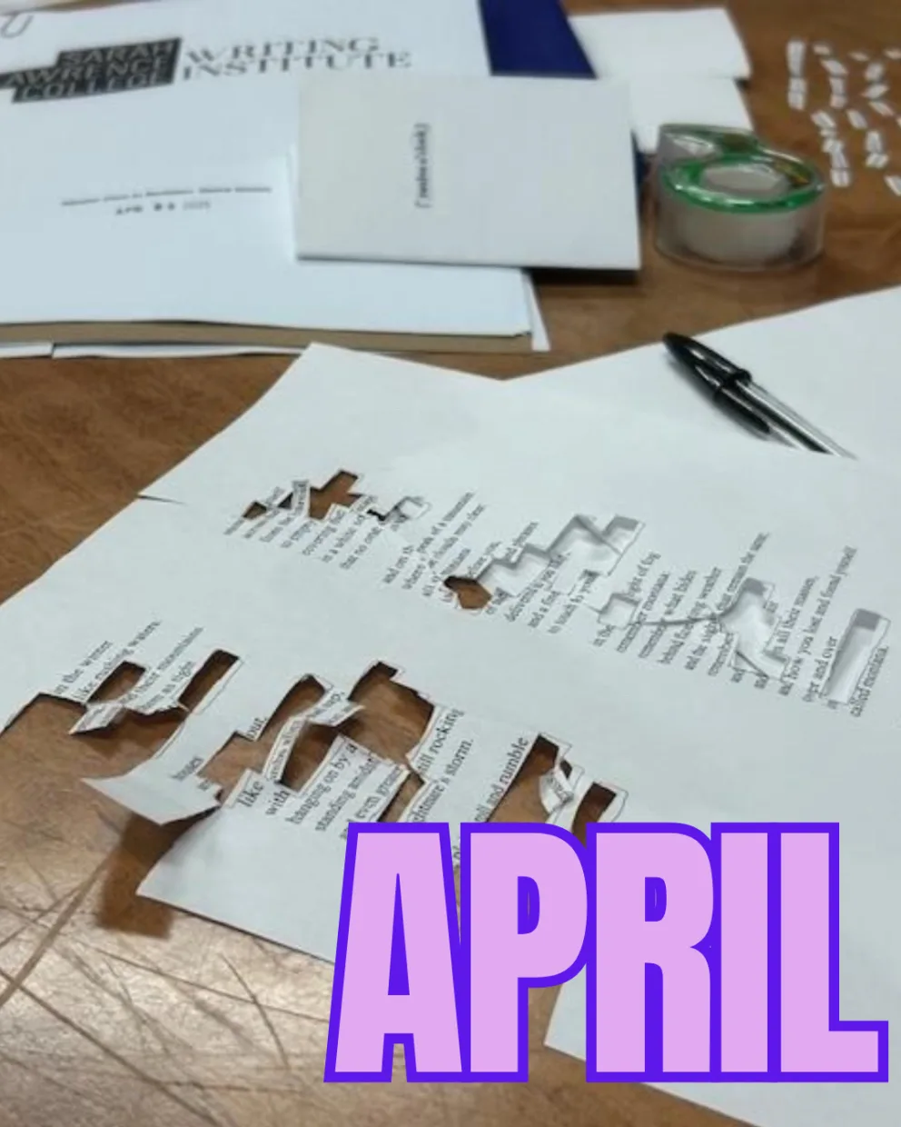 Papers with cut-out words on a table, along with a pen and tape. Large purple text at the bottom reads "APRIL."