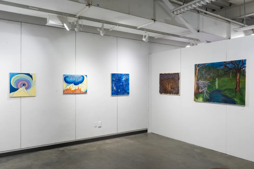 Art gallery with five abstract and landscape paintings on white walls, exhibit lighting spotlighting the artworks.