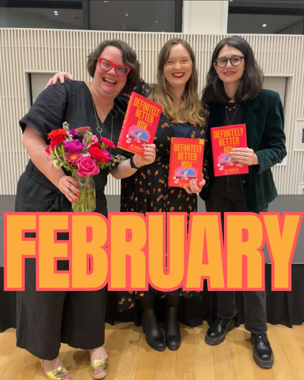 Three people smile, holding the book "Definitely Better Now." One holds flowers. The word "FEBRUARY" is prominently displayed in front.