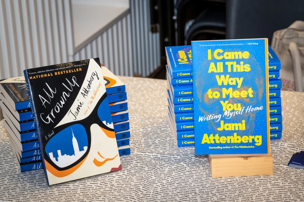 a table topped with a stack of books next to a pile of books on top of a wooden table