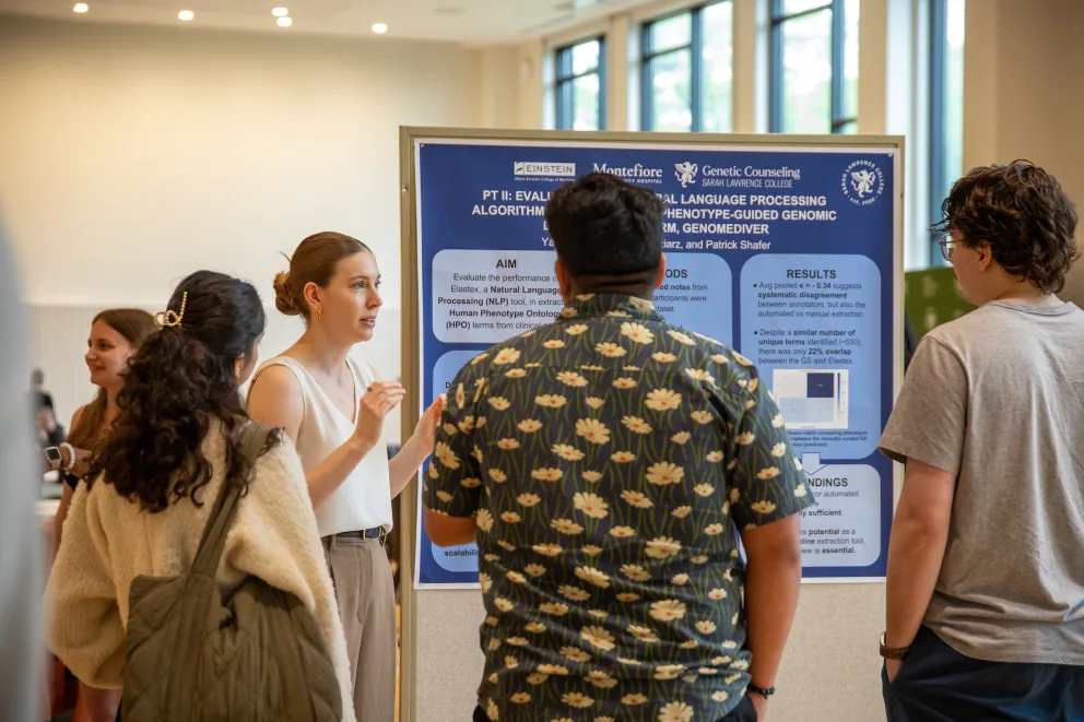 Person explaining a research poster to a group of attendees at an event. The poster includes sections on aims, methods, results, and findings.