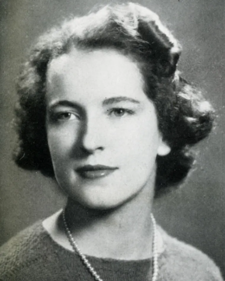 Vintage black and white portrait of a person with a necklace.