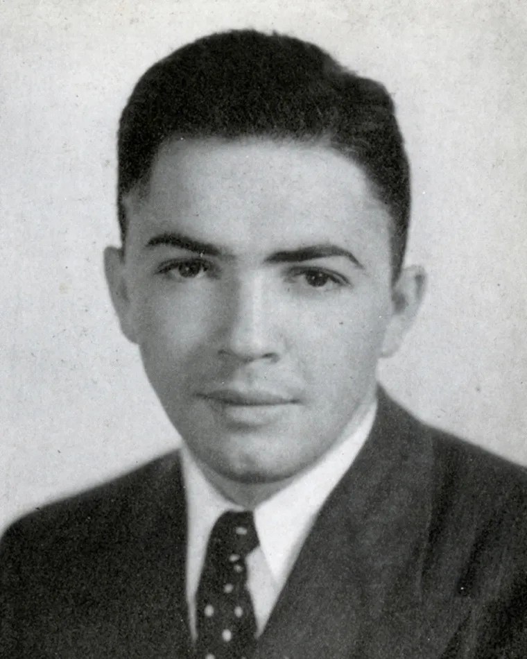 Vintage black and white portrait of a person with a neat haircut in a suit and tie.