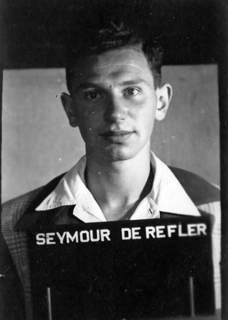 Vintage black and white portrait with "SEYMOUR DE REFLER" sign.