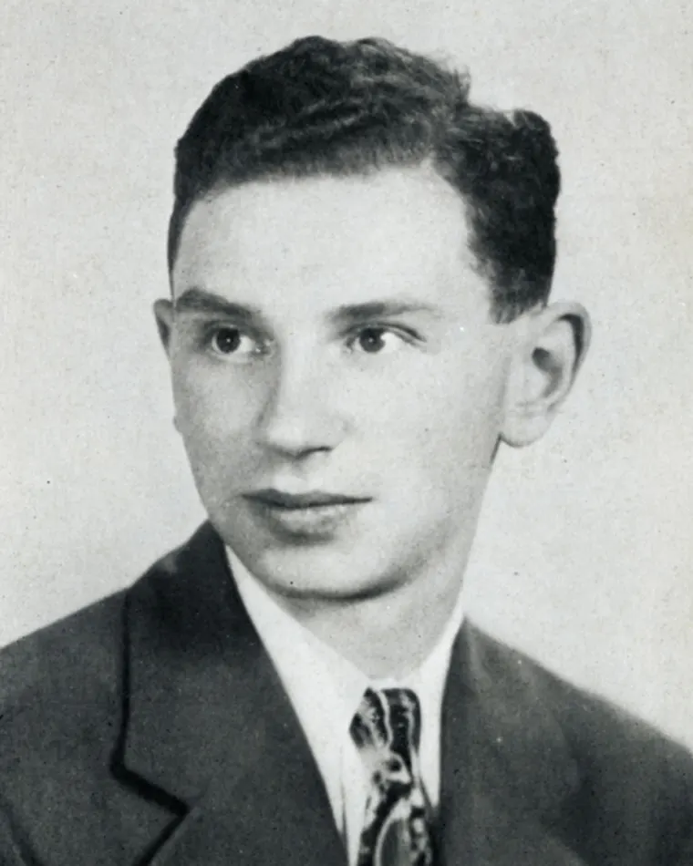 Vintage black and white portrait of a person with short hair, wearing a suit and tie.