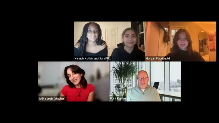 A video call with six people, five smiling at their cameras. A bright room with a plant is visible in one participant's background.