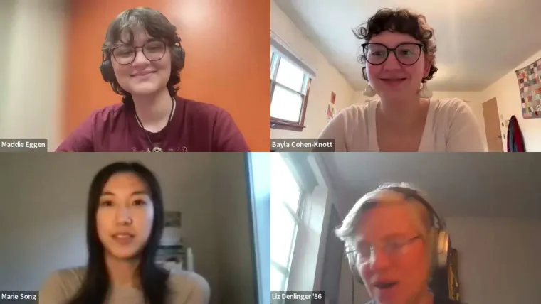 Four individuals in a video call, all wearing glasses. Two are smiling with headphones, one has long hair, and the other is slightly blurry.