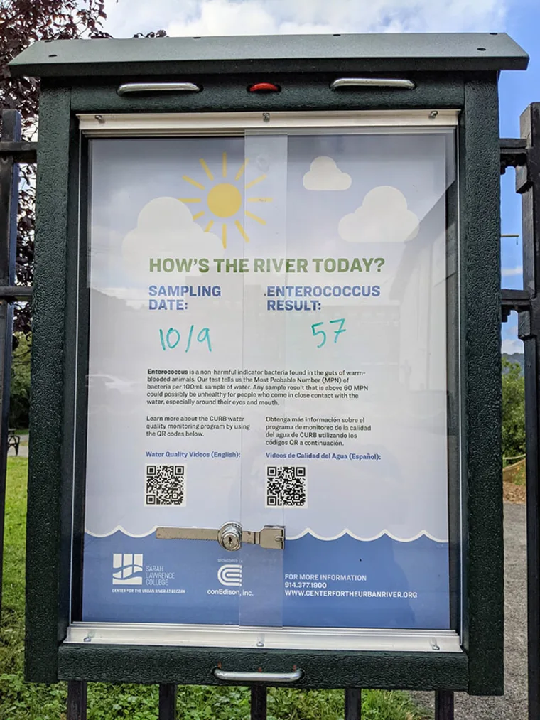 Information board shows river sampling date as 10/9 and Enterococcus result as 57, with QR codes and details about water quality.