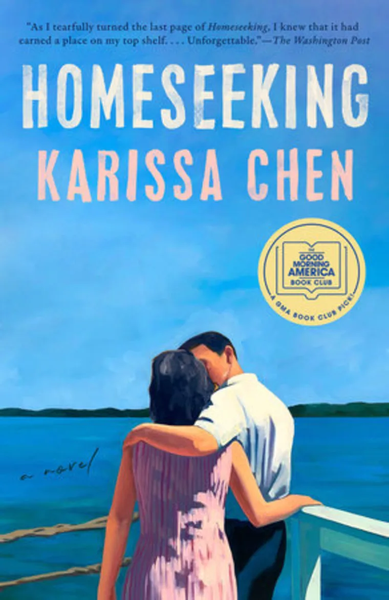 Book cover of "Homeseeking" by Karissa Chen. Two people embrace on a lakeside pier under a blue sky. Good Morning America Book Club seal visible.