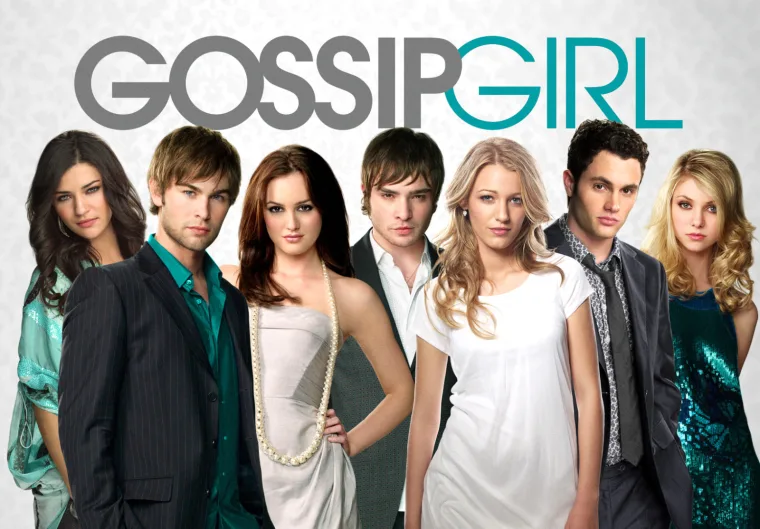 A group of seven people dressed stylishly, standing in front of the "Gossip Girl" logo.