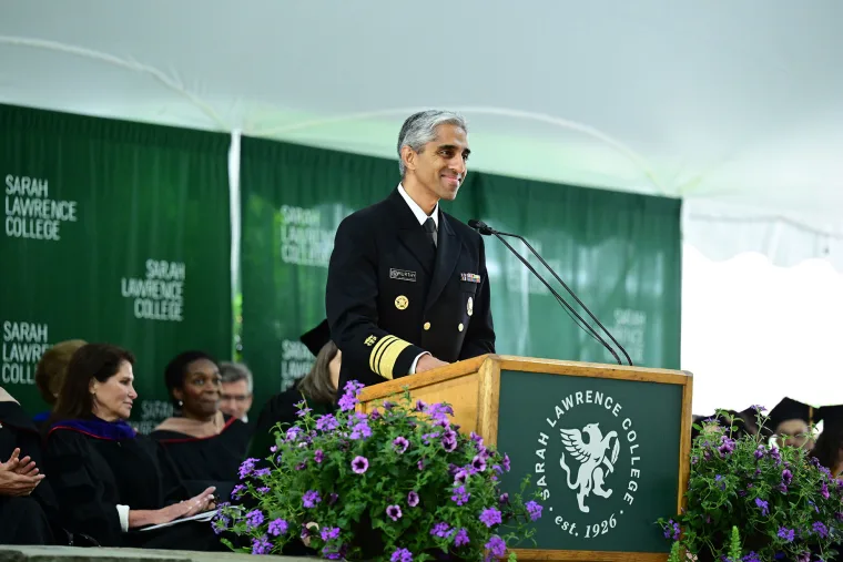 Surgeon General Dr. Vivek Murthy speaking at a podium.