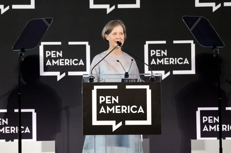 Person speaking at a podium with "PEN America" logo in the background, flanked by teleprompters.