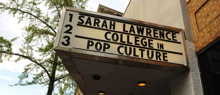Marquee sign reads "Sarah Lawrence College in Pop Culture" with tree branches visible in the background.