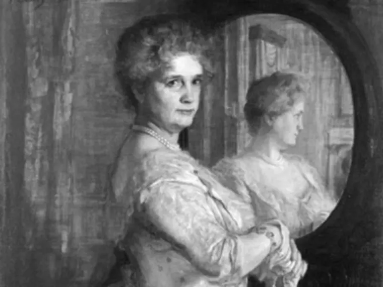 A person in formal attire looks at the viewer, standing beside a mirror reflecting their profile. The setting appears historical or vintage.