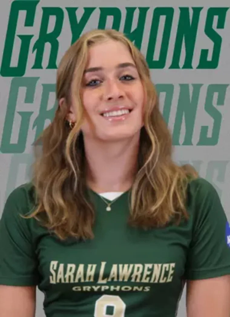 Person with long hair smiling, wearing a green "Sarah Lawrence Gryphons" jersey with the number 9. Background says "Gryphons."