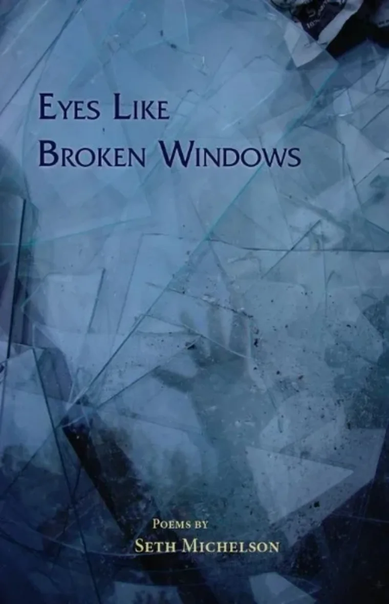 Book cover titled "Eyes Like Broken Windows" by Seth Michelson, showing cracked glass with a handprint in the background.