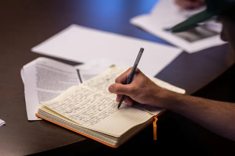 closeup of student writing in their journal