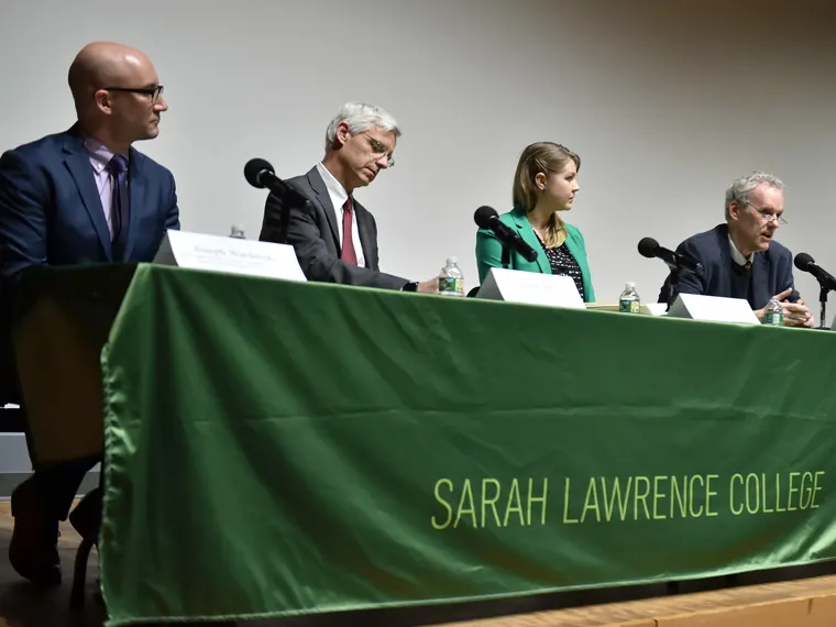 Four panelists sit at a table with microphones at a Sarah Lawrence College event.
