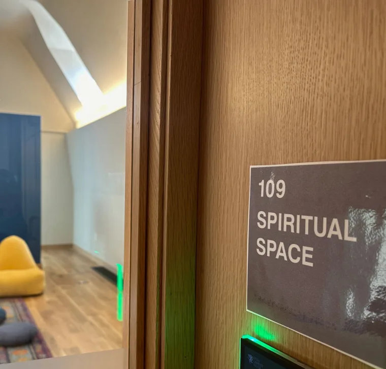 Room 109 labeled "Spiritual Space" with a view inside showing a yellow bean bag chair, cushions, and a rug on a wooden floor.