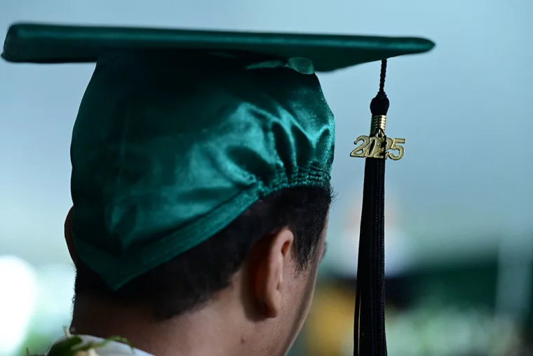 Graduate in green cap seen from behind, tassel hanging with the year "2025" in gold.