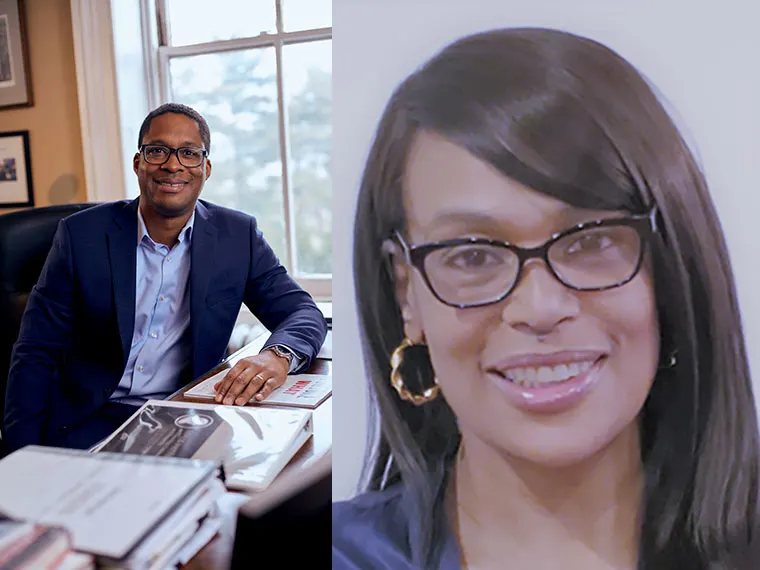Two people side by side: one in a suit at a desk, the other with glasses and long hair, smiling.