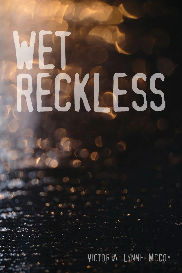 Book cover titled "Wet Reckless" with bokeh lights in the background and the name Victoria Lynne McCoy at the bottom.