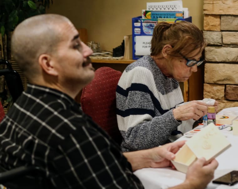 Residents sitting at a craft table