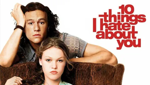 Two people, one resting on the arm of a couch, with text "10 Things I Hate About You" beside them.