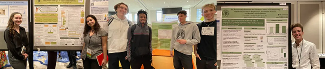 Seven people stand beside scientific posters in a conference setting, smiling for a group photo.