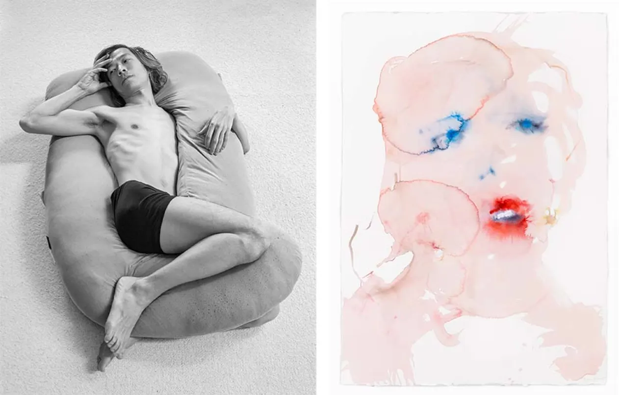 Person reclining on a beanbag in black shorts, next to a watercolor painting of an abstract face with blue eyes and red lips.