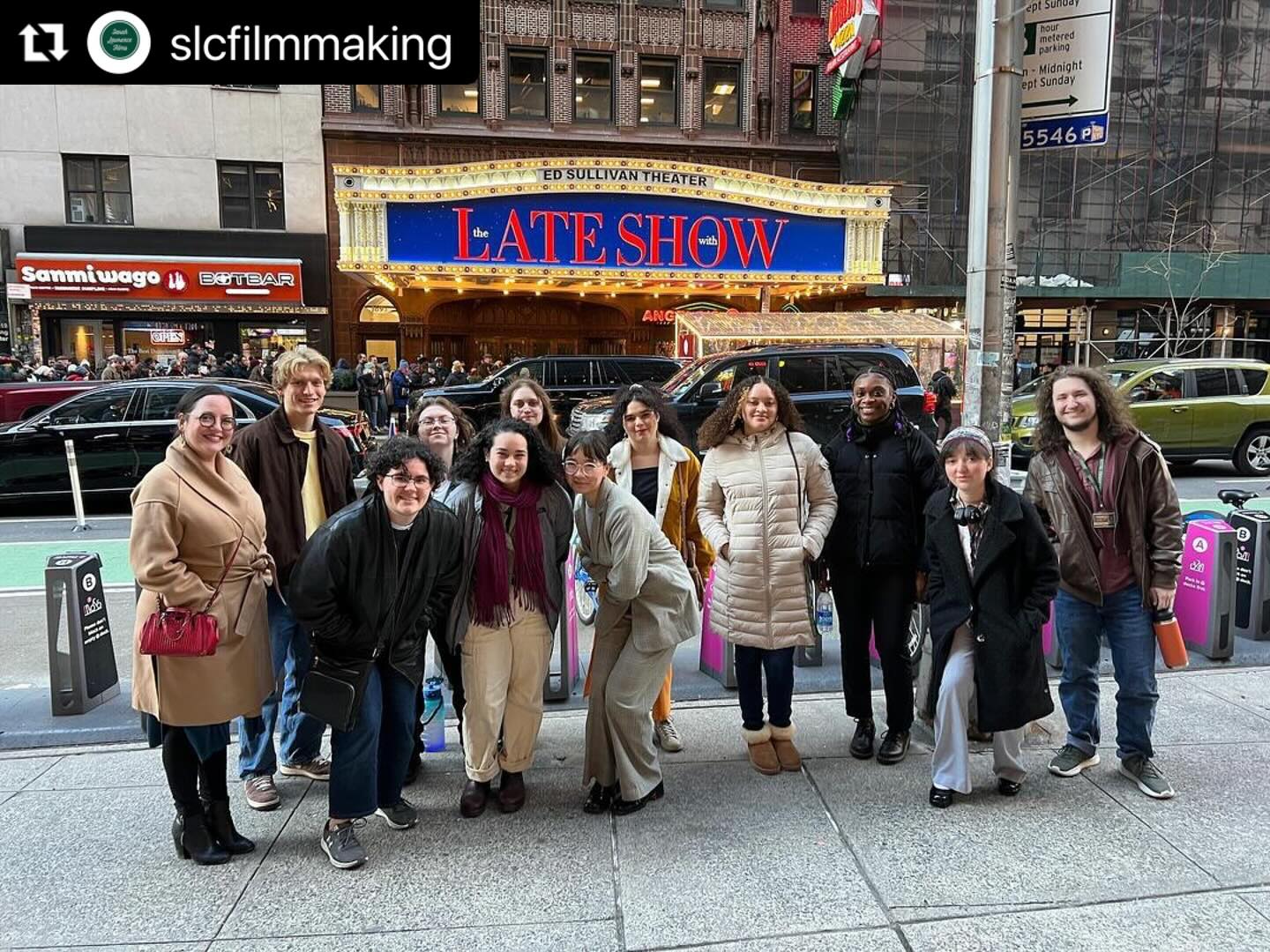 Students standing outside in front of the Late Show Theater.