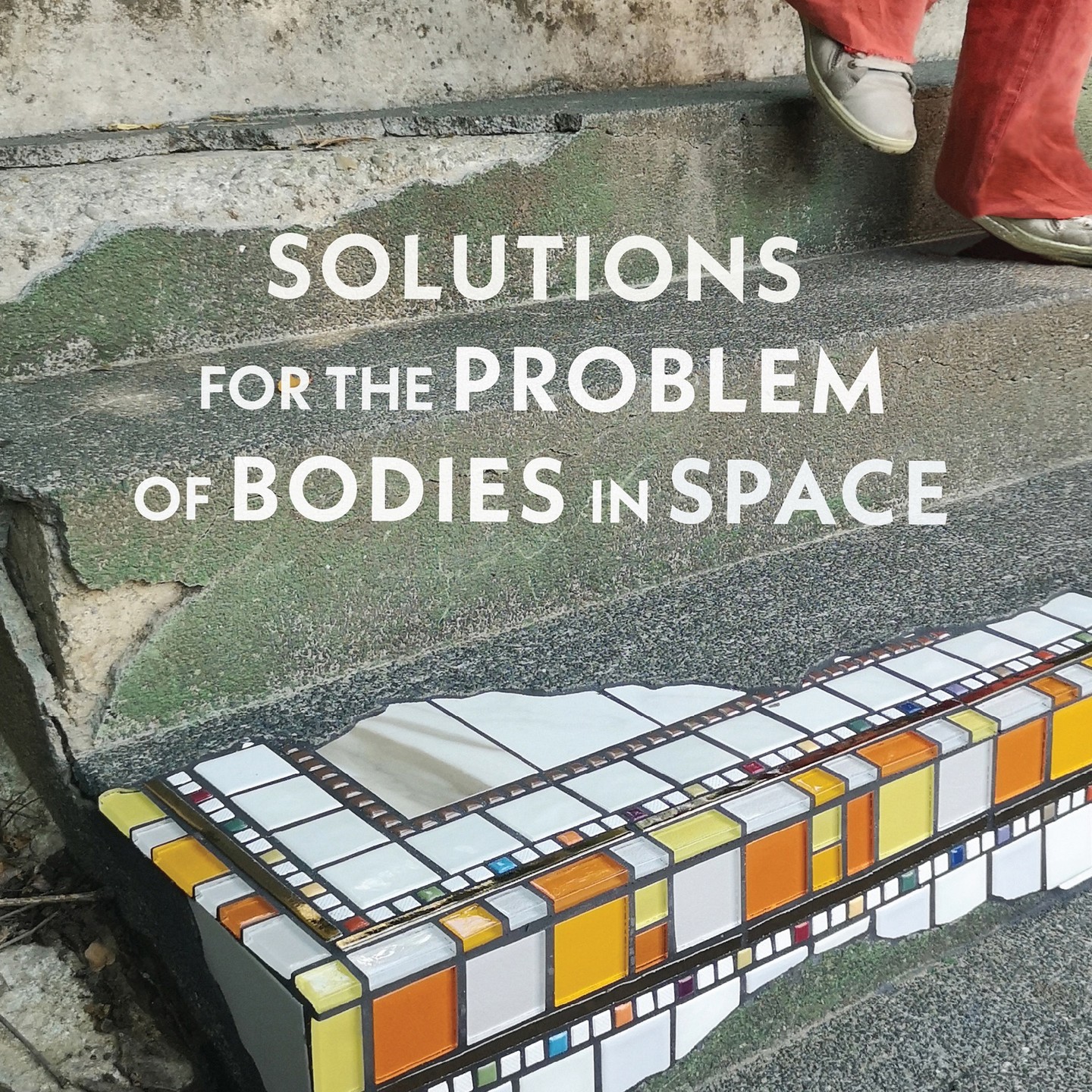 Text on a wall: &quot;SOLUTIONS FOR THE PROBLEM OF BODIES IN SPACE&quot;, a tiled edge, and a person's legs.