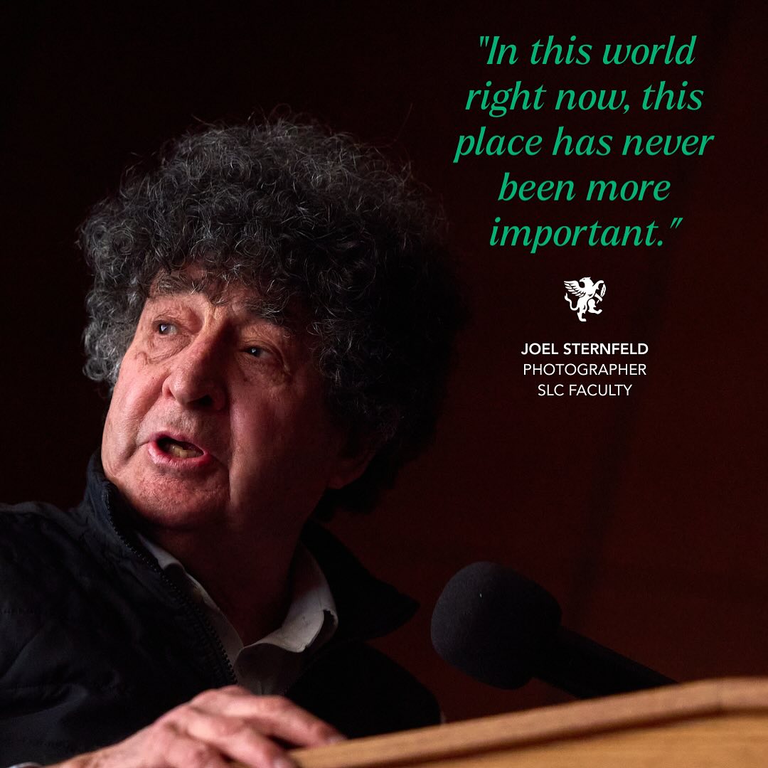 Person speaking into a microphone at a podium with text beside them reading, &quot;In this world right now, this place has never been more important.&quot;