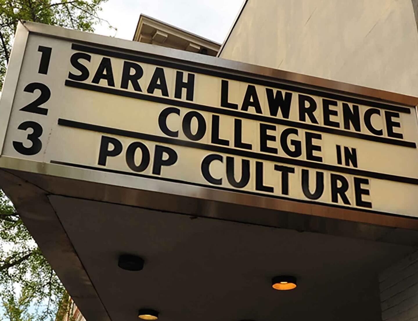 Marquee sign with text: "1. Sarah Lawrence, 2. College in, 3. Pop Culture." Building and tree partially visible.