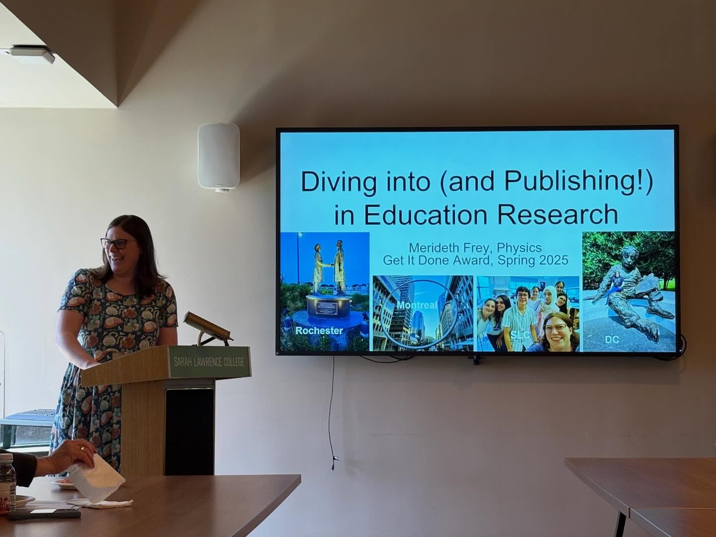 Person at a podium labeled "Sarah Lawrence College" gives a presentation on education research, with slides showing various city images.