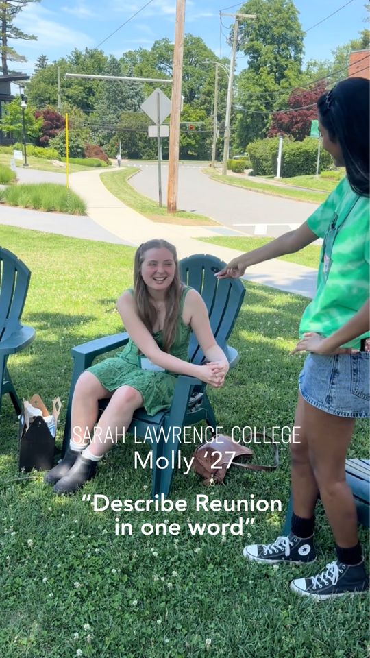 Person sitting on a chair outside, smiling at someone standing and pointing. Text reads: “Sarah Lawrence College, Molly ’27, Describe Reunion in one word.”