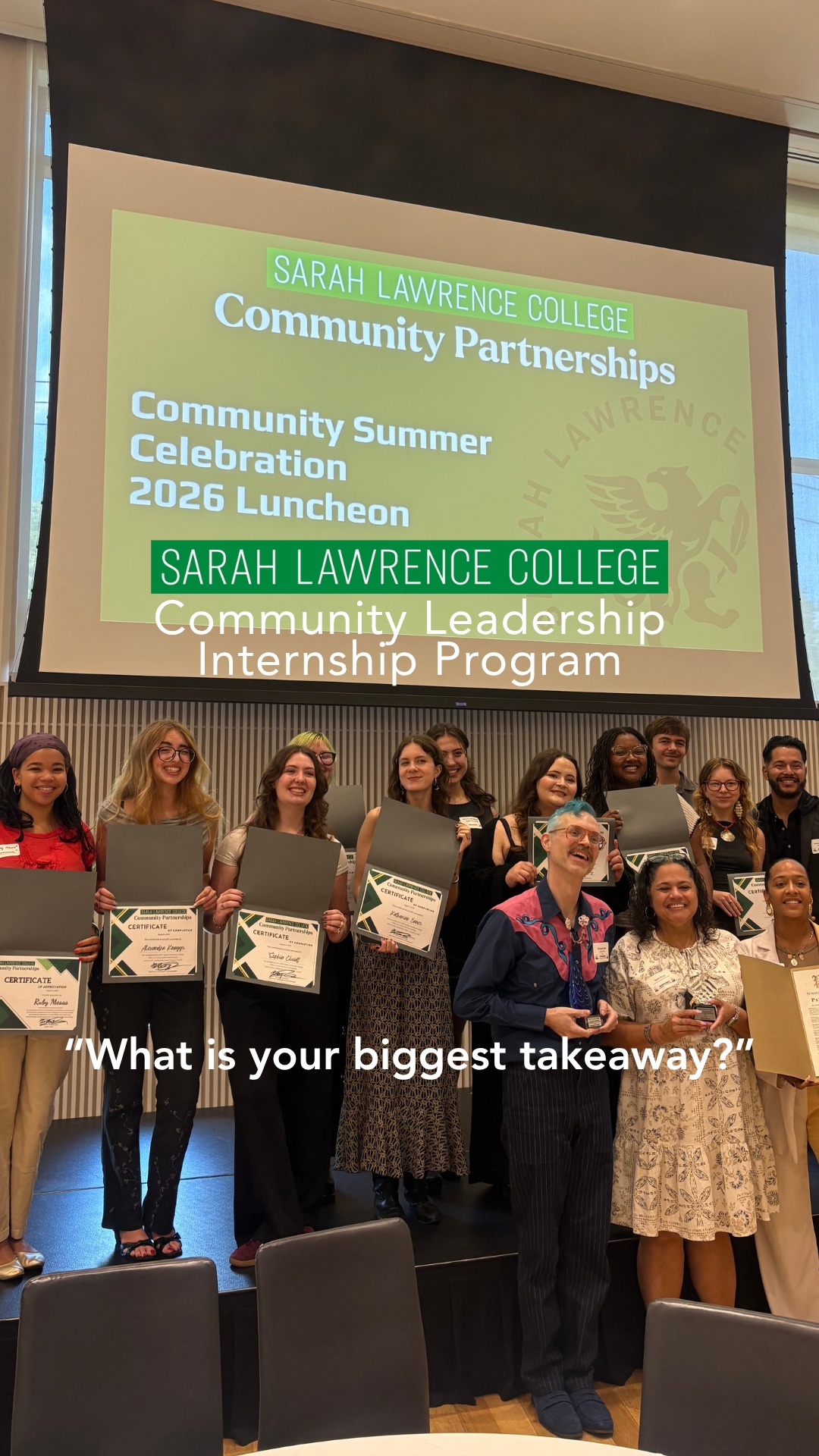 A group of individuals on stage hold certificates under a projected slide about Sarah Lawrence College's community leadership program.