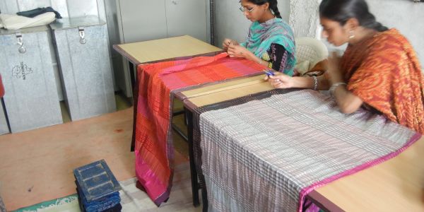 Inspecting the finished weavings