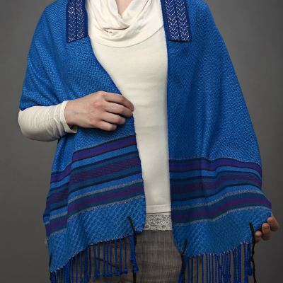 A multi-colored striped border on this prayer shawl