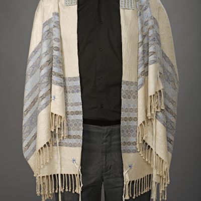 Embroidery surrounds opening for tzitzit